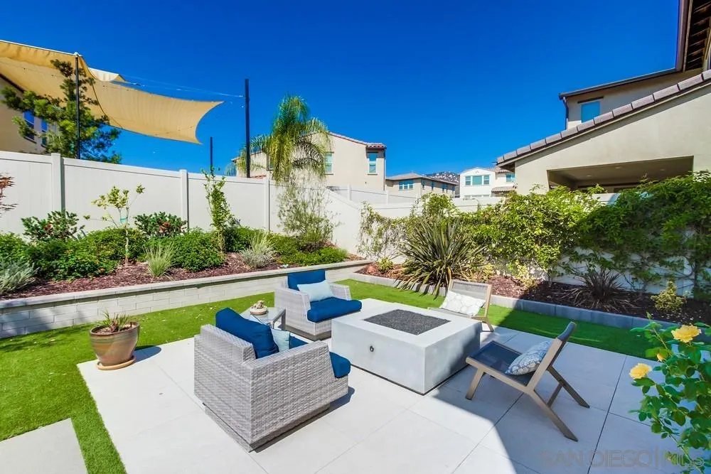 1933 Pascal Court Escondido, CA 92026 - Photo 51 of 52 a view of a patio with couches table and chairs under an umbrella