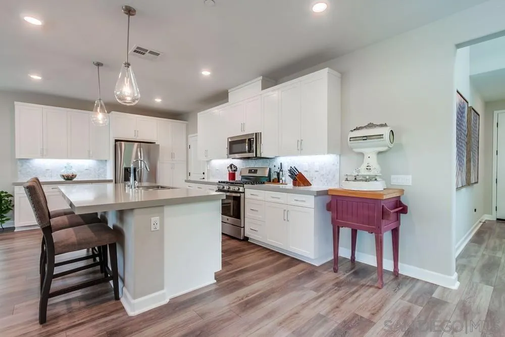 1933 Pascal Court Escondido, CA 92026 - Photo 9 of 52 a kitchen with a sink cabinets and wooden floor