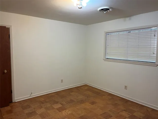 an empty room with a empty space and a window