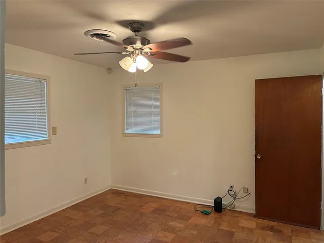 a view of a room with a fan and a window
