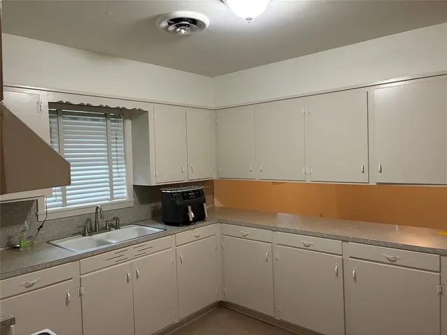 a kitchen with a sink and cabinets