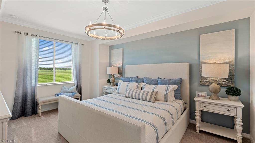 5467 Double Eagle Circle, Unit 3225 Ave Maria, FL 34142 - Photo 15 of 31 a bedroom with a bed and a chandelier
