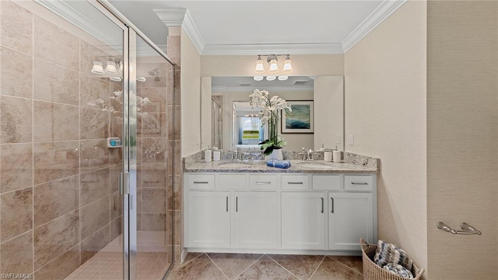 5467 Double Eagle Circle, Unit 3225 Ave Maria, FL 34142 - Photo 17 of 31 a bathroom with a granite countertop sink a mirror and a shower