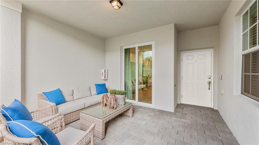 5467 Double Eagle Circle, Unit 3225 Ave Maria, FL 34142 - Photo 2 of 31 a living room with furniture and a window