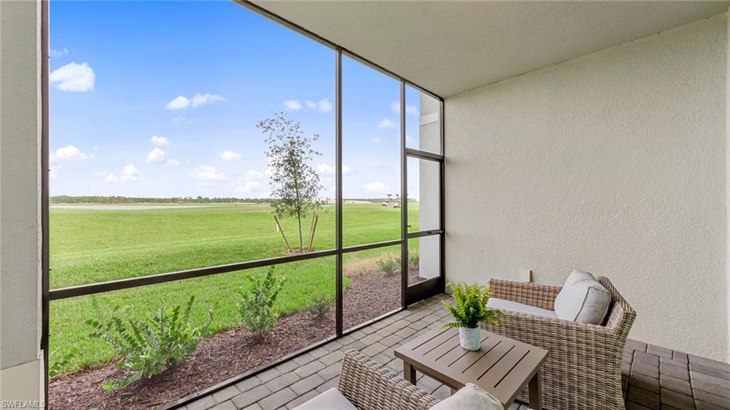 5467 Double Eagle Circle, Unit 3225 Ave Maria, FL 34142 - Photo 24 of 31 a view of a balcony with chair and wooden floor