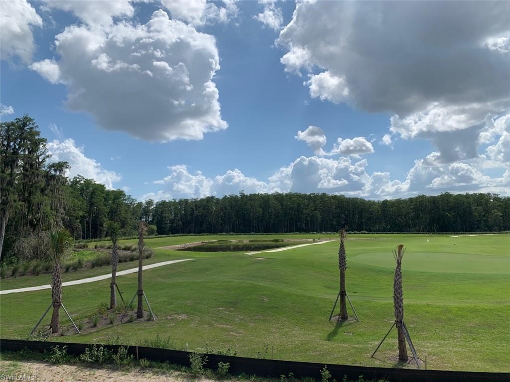 5467 Double Eagle Circle, Unit 3225 Ave Maria, FL 34142 - Photo 26 of 31 a view of a golf course with a lake