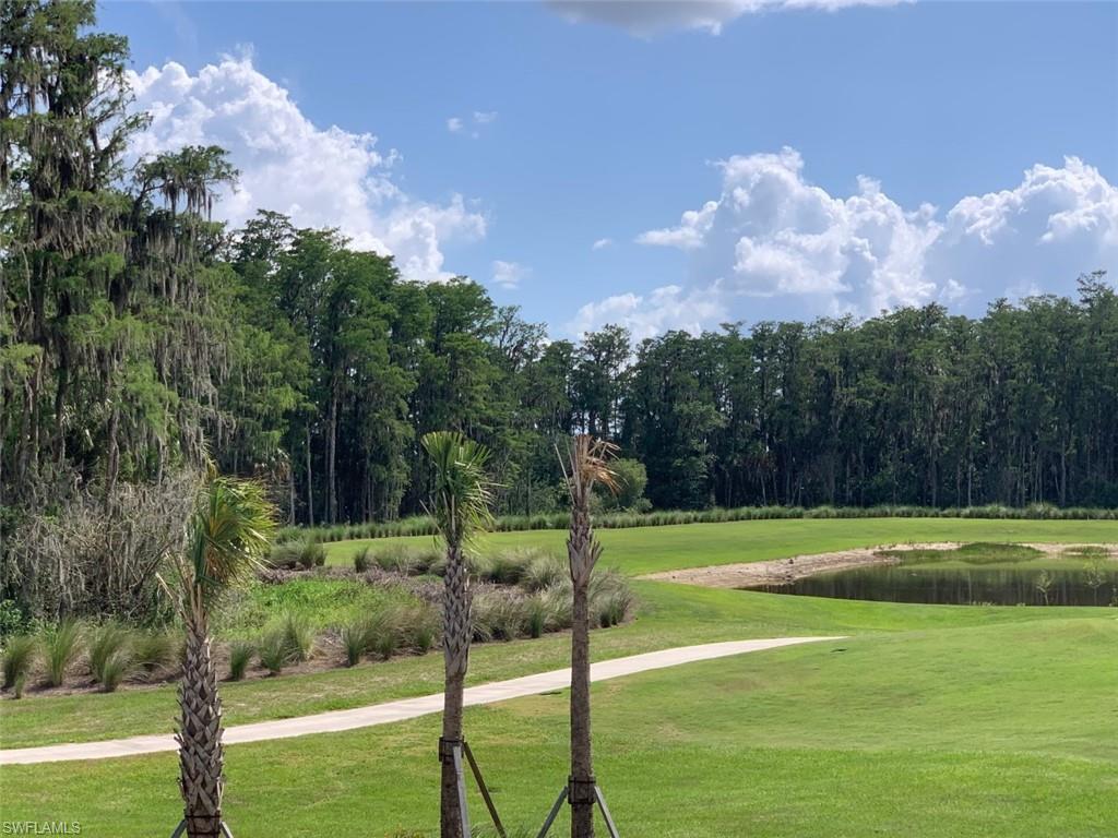 5467 Double Eagle Circle, Unit 3225 Ave Maria, FL 34142 - Photo 27 of 31 a view of a golf course with a lake