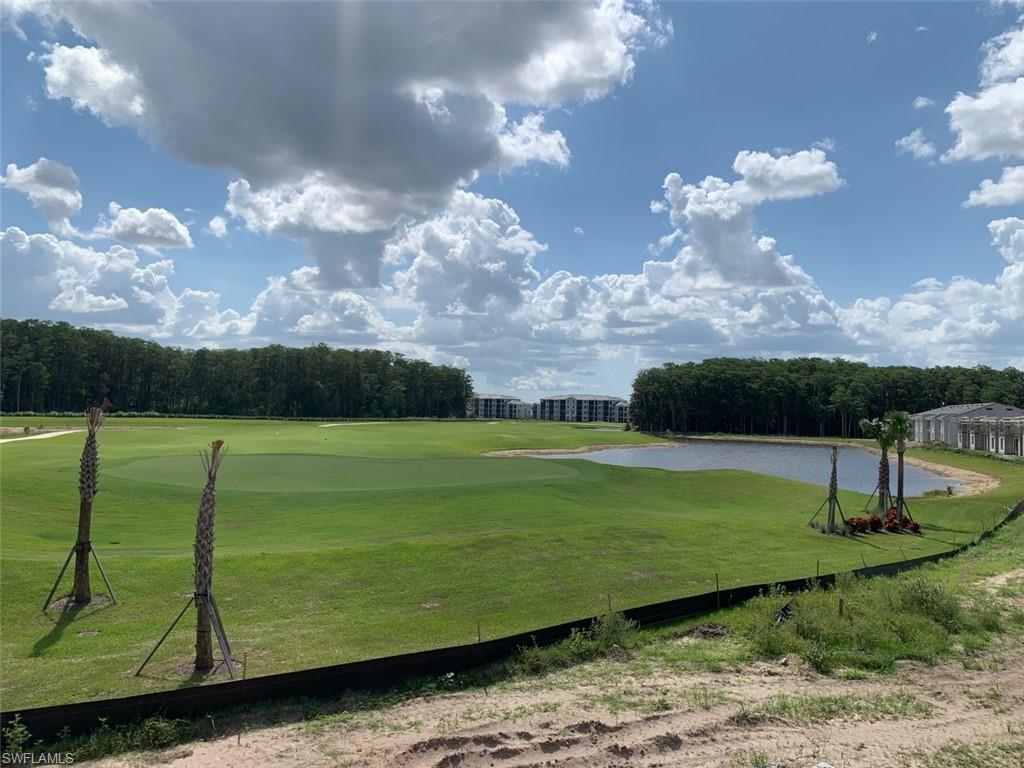 5467 Double Eagle Circle, Unit 3225 Ave Maria, FL 34142 - Photo 29 of 31 a view of a golf course with a lake