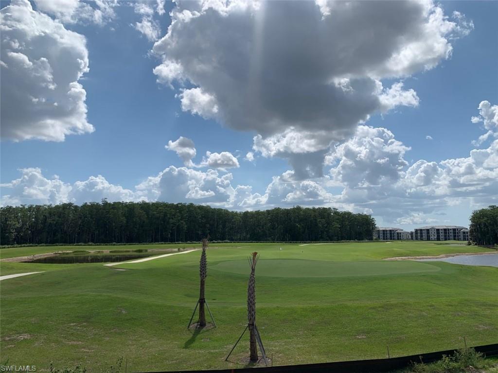 5467 Double Eagle Circle, Unit 3225 Ave Maria, FL 34142 - Photo 30 of 31 a view of a golf course with a lake