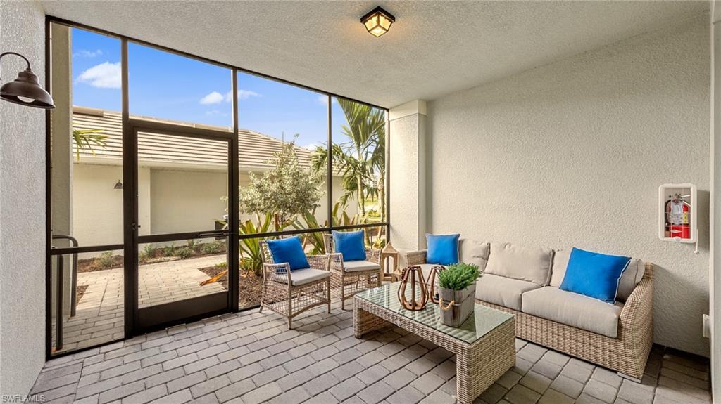 5467 Double Eagle Circle, Unit 3225 Ave Maria, FL 34142 - Photo 3 of 31 a living room with furniture and a large window