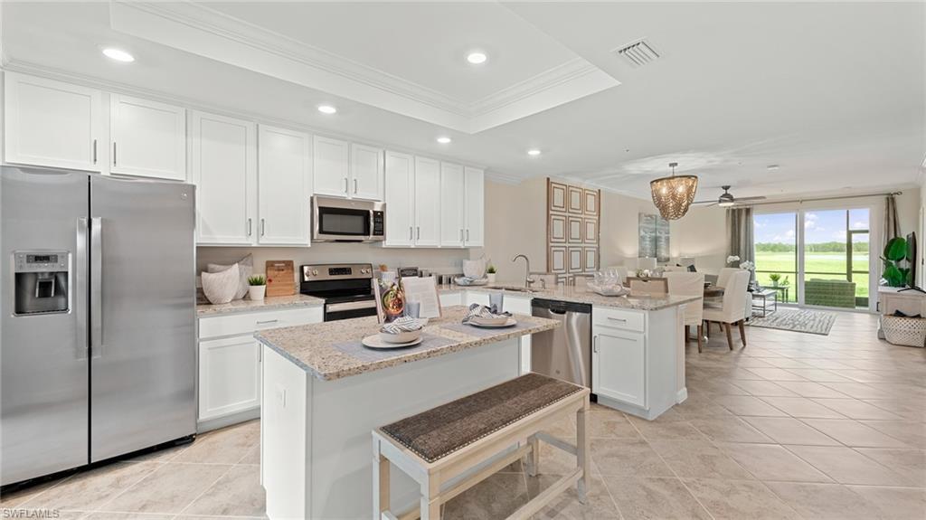 5467 Double Eagle Circle, Unit 3225 Ave Maria, FL 34142 - Photo 4 of 31 a kitchen with a refrigerator and a stove top oven