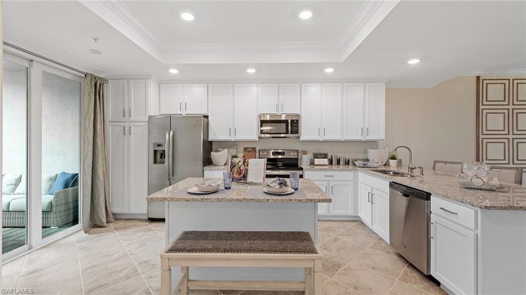 5467 Double Eagle Circle, Unit 3225 Ave Maria, FL 34142 - Photo 5 of 31 a kitchen with stainless steel appliances granite countertop a refrigerator sink and white cabinets