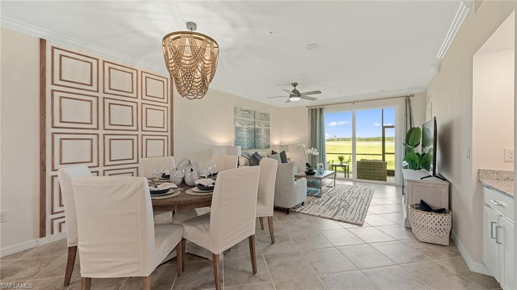 5467 Double Eagle Circle, Unit 3225 Ave Maria, FL 34142 - Photo 9 of 31 a living room with furniture a window and a chandelier
