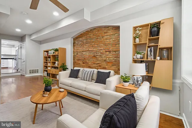 a living room with furniture and a potted plant