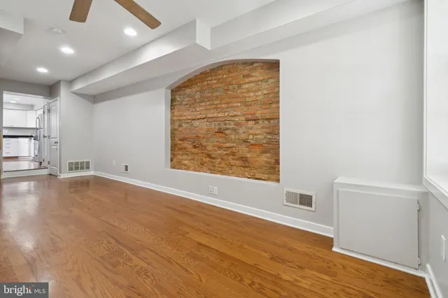 an empty room with windows and closet