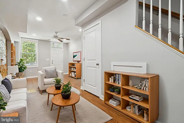 a living room with furniture and a book shelf