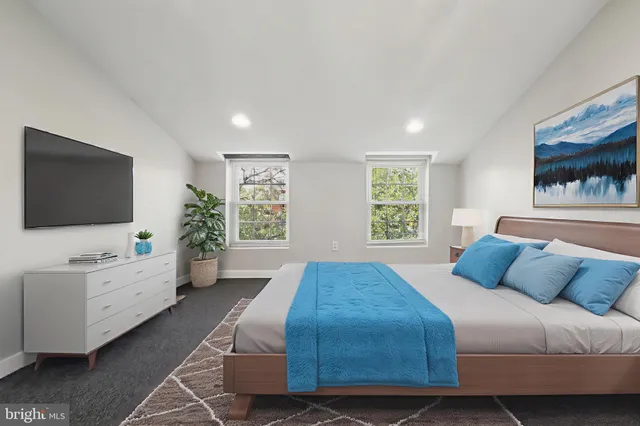 a bedroom with a bed and a flat screen tv