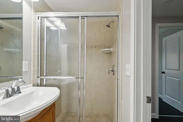 a bathroom with a sink and shower