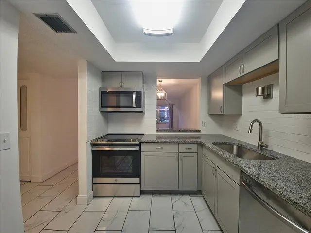 a kitchen with a sink stove and microwave
