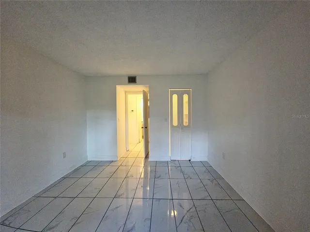 a view of an empty room with a window