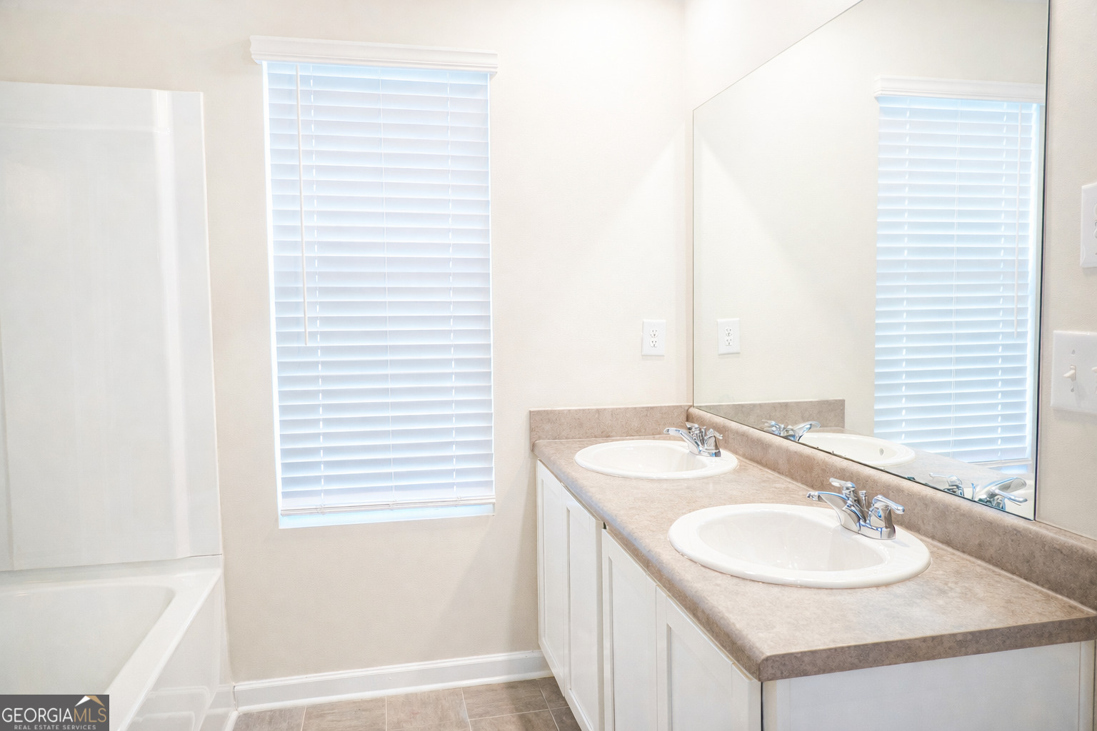 11922 Lovejoy Crossing Way Hampton, GA 30228 - Photo 13 of 15 a bathroom with a sink and a mirror