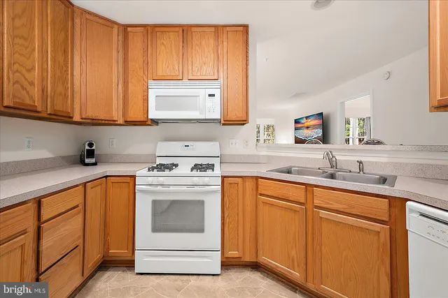 a kitchen with granite countertop cabinets stainless steel appliances and sink