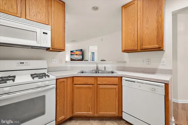 a kitchen with cabinets appliances and a sink