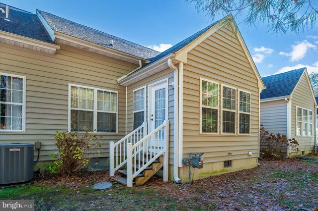 a view of house with a deck and furniture