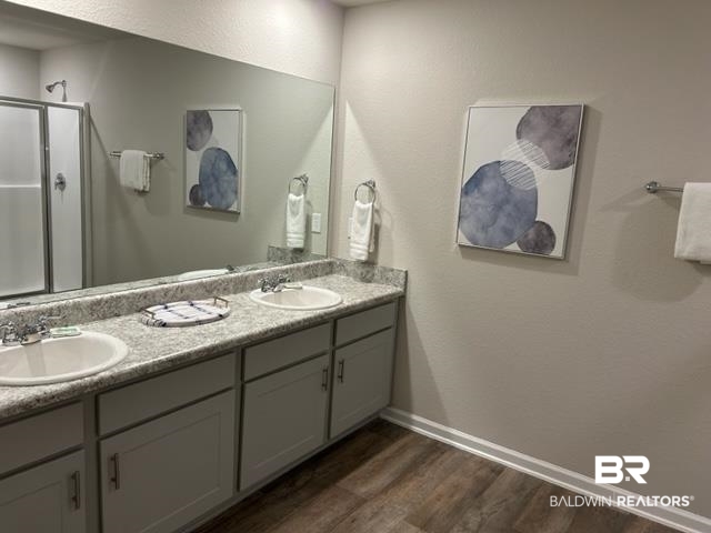 7409 Brompton Drive Foley, AL 36535 - Photo 9 of 18 Bathroom featuring vanity, a shower with shower door, and hardwood / wood-style floors