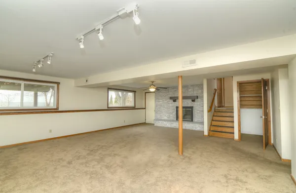 an empty room with a window and a fan