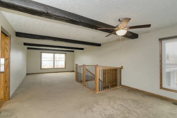 a view of a room with a table and chairs