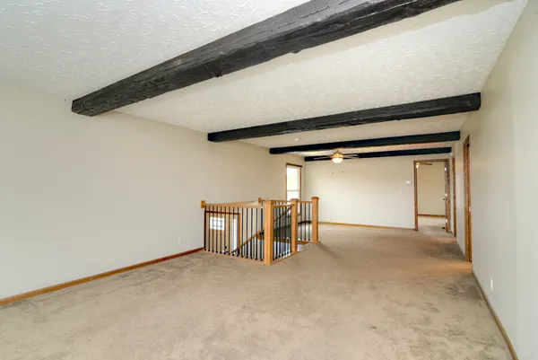 a kitchen with stainless steel appliances granite countertop a refrigerator a sink dishwasher a stove and white countertops with wooden floor