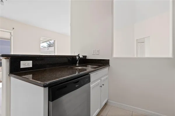 a kitchen that has a sink and a stove top oven