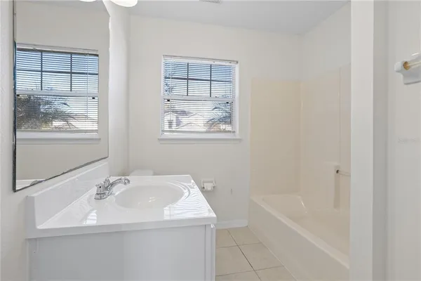 a bathroom with a sink a bathtub and a shower