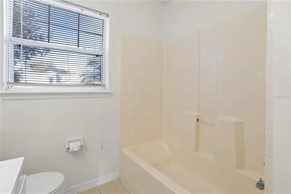 a white bath tub sitting next to a white toilet