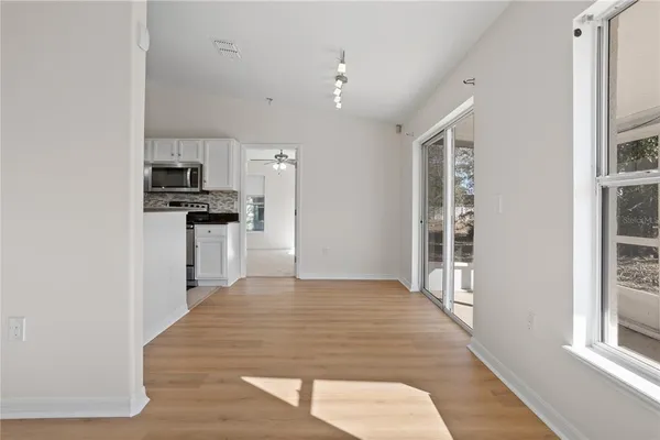 a kitchen with stainless steel appliances a refrigerator and a stove top oven