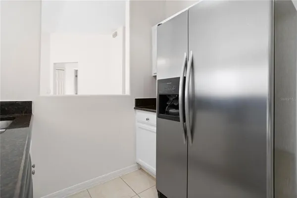a metallic refrigerator freezer sitting in a kitchen