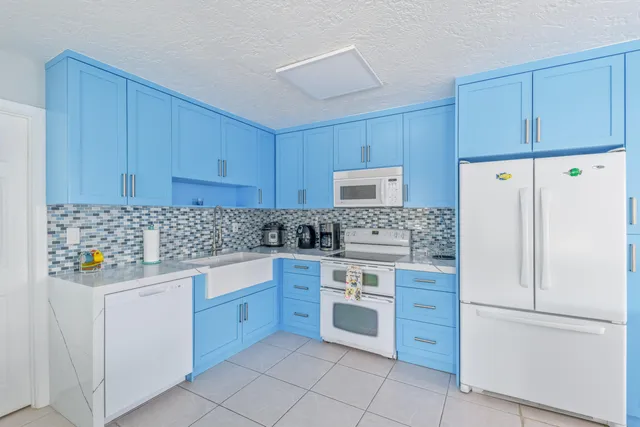 a kitchen with stainless steel appliances granite countertop a refrigerator and a stove