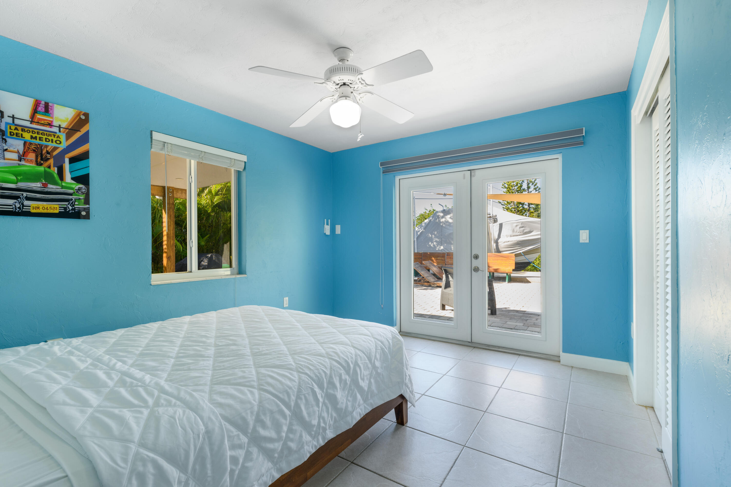 8260 Aviation Boulevard Marathon, FL 33050 - Photo 23 of 36 a bedroom with a bed and a painting on the wall