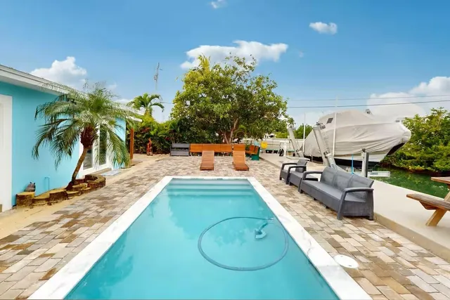 swimming pool view with a seating space