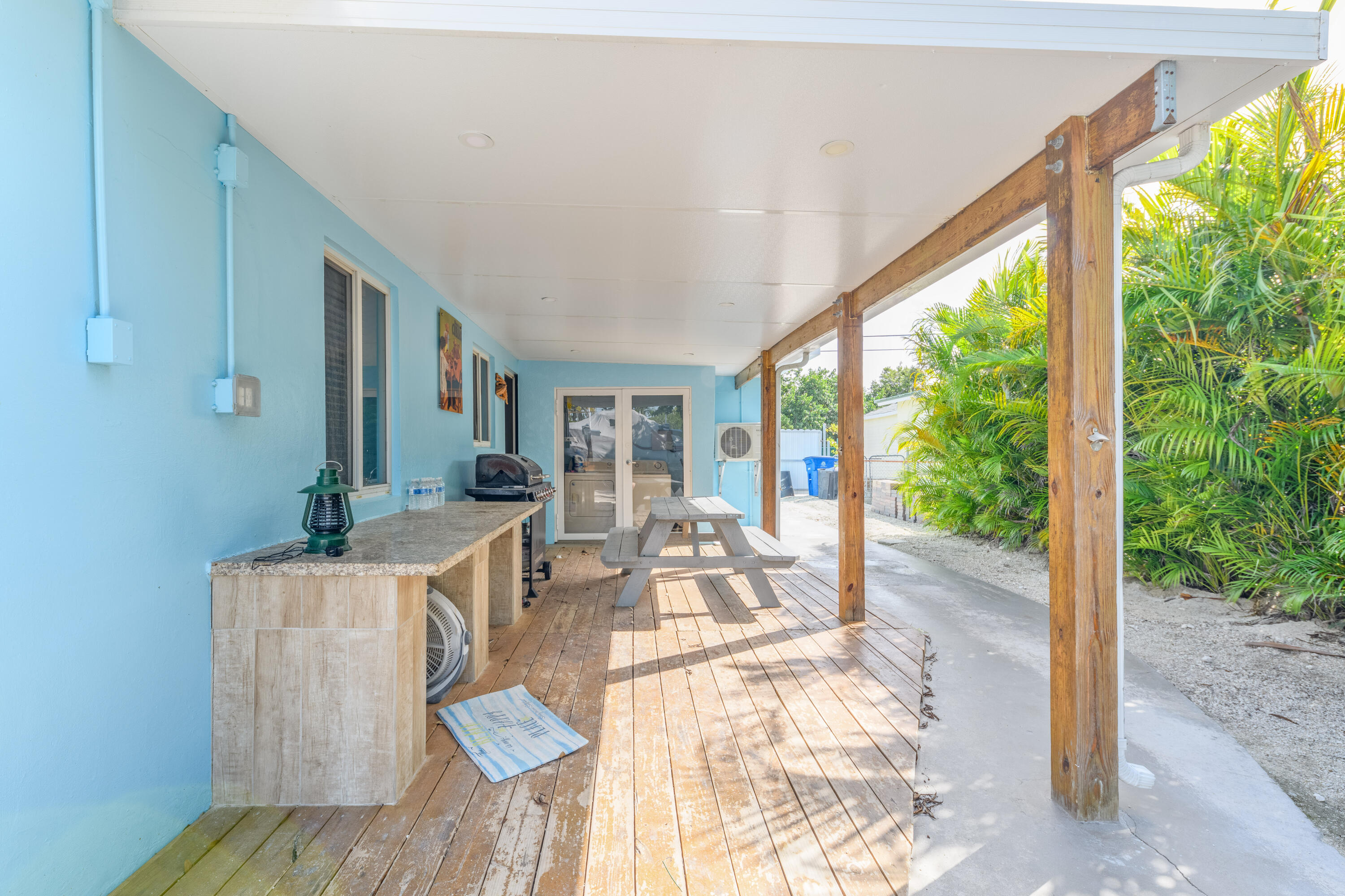 8260 Aviation Boulevard Marathon, FL 33050 - Photo 32 of 36 a living room with furniture and a floor to ceiling window
