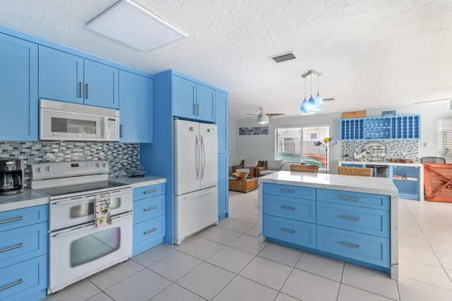 a kitchen with kitchen island wooden cabinets and stainless steel appliances