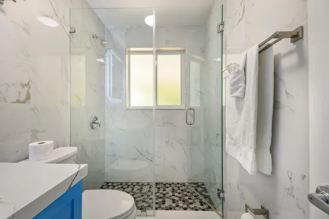 a bathroom with a sink toilet and shower