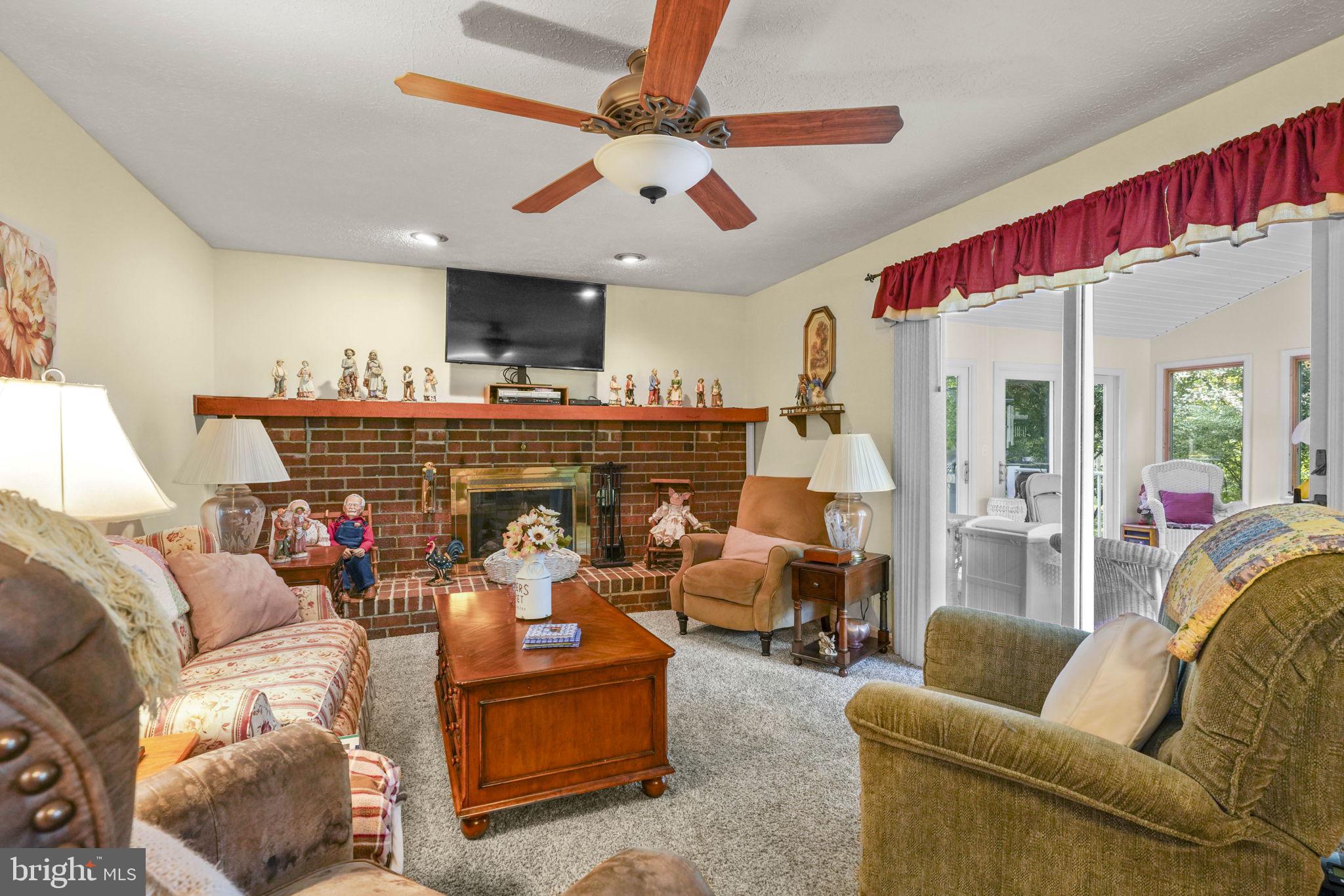 4949 Idlewilde Road Shady Side, MD 20764 - Photo 11 of 28 a living room with furniture a flat screen tv and a window