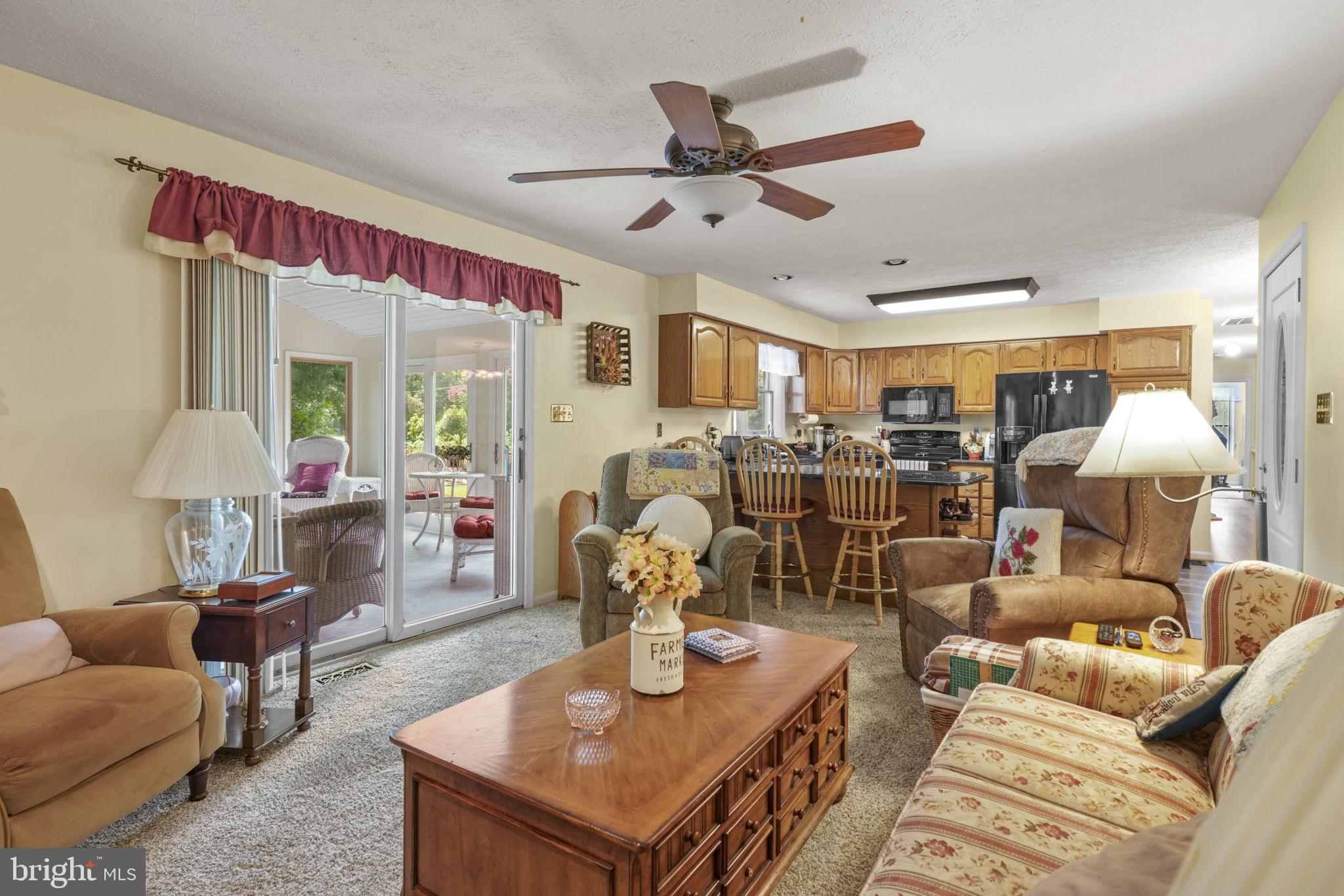 4949 Idlewilde Road Shady Side, MD 20764 - Photo 12 of 28 a living room with furniture and a chandelier