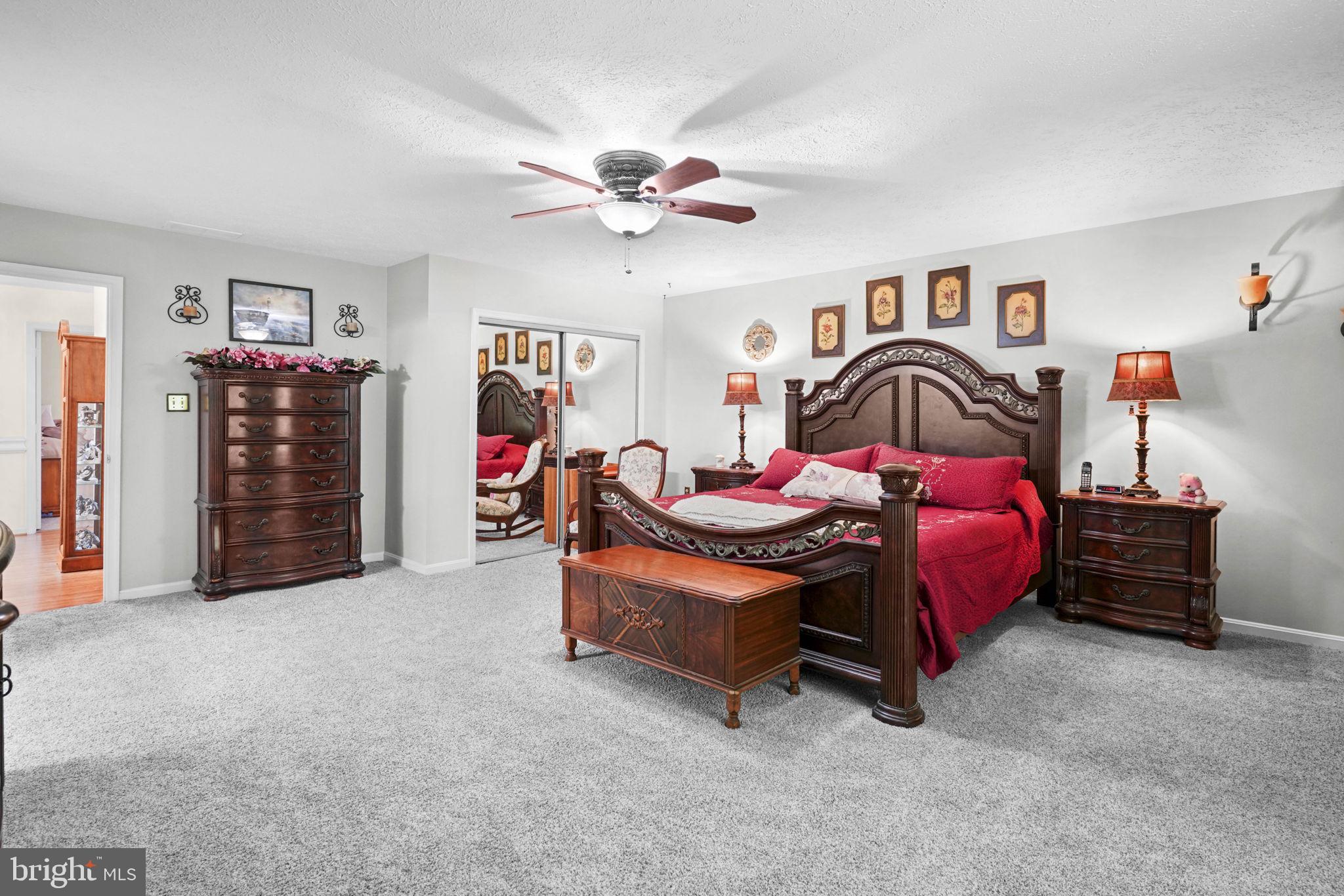 4949 Idlewilde Road Shady Side, MD 20764 - Photo 15 of 28 a bedroom with furniture and a chandelier