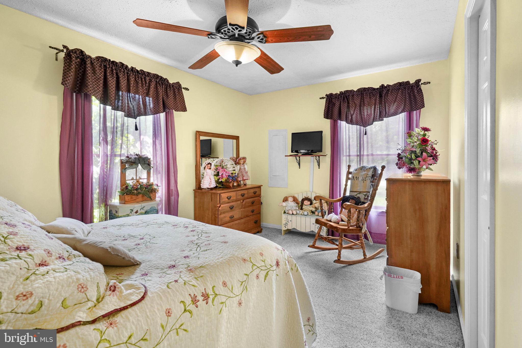 4949 Idlewilde Road Shady Side, MD 20764 - Photo 18 of 28 a bed room with a bed and a chair