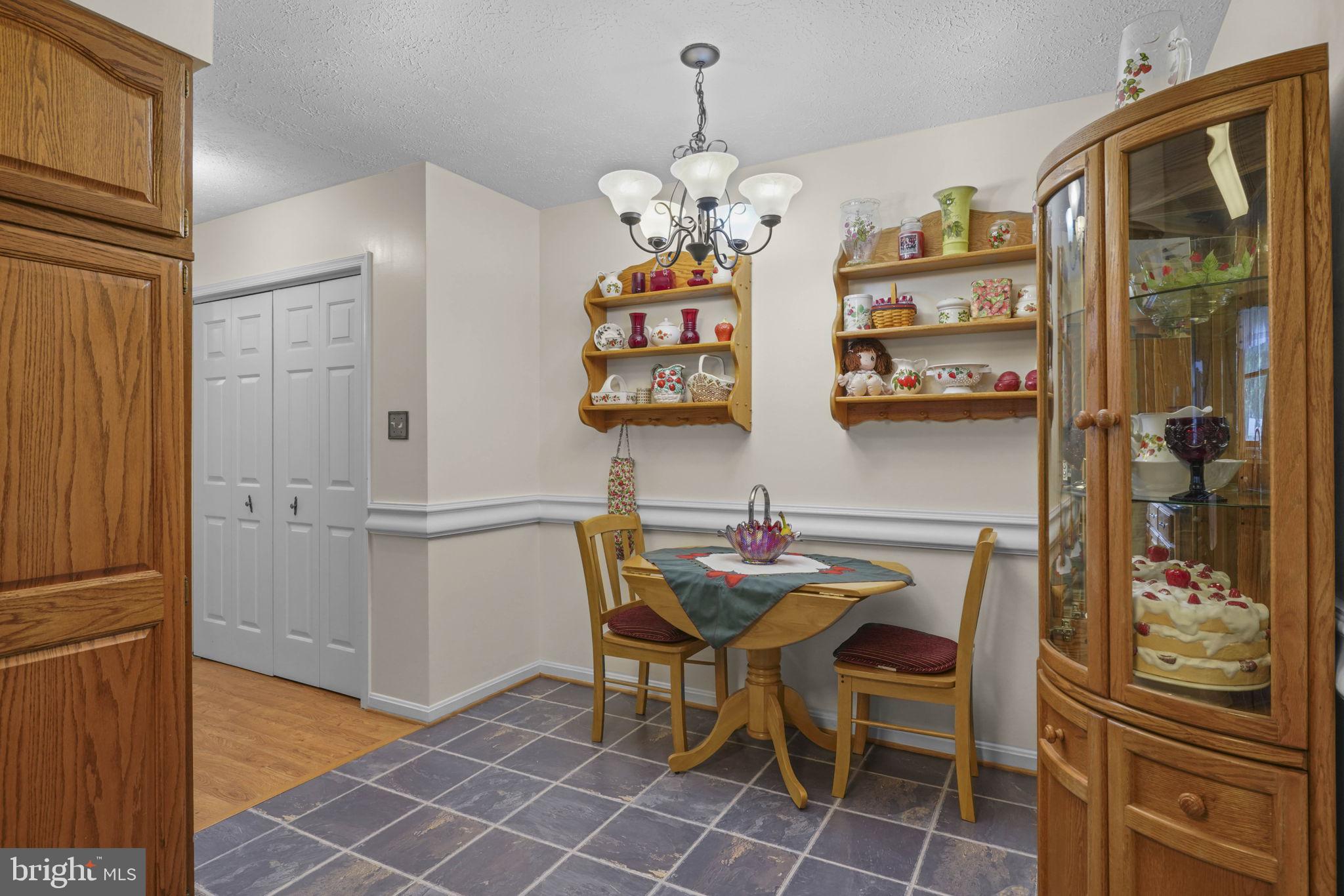 4949 Idlewilde Road Shady Side, MD 20764 - Photo 10 of 28 a view of a dining room with furniture and a chandelier