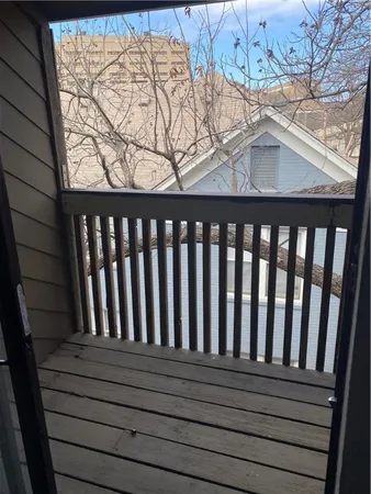 a view of balcony with wooden floor