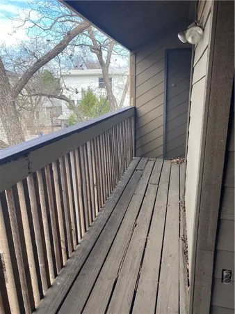 a balcony with wooden floor